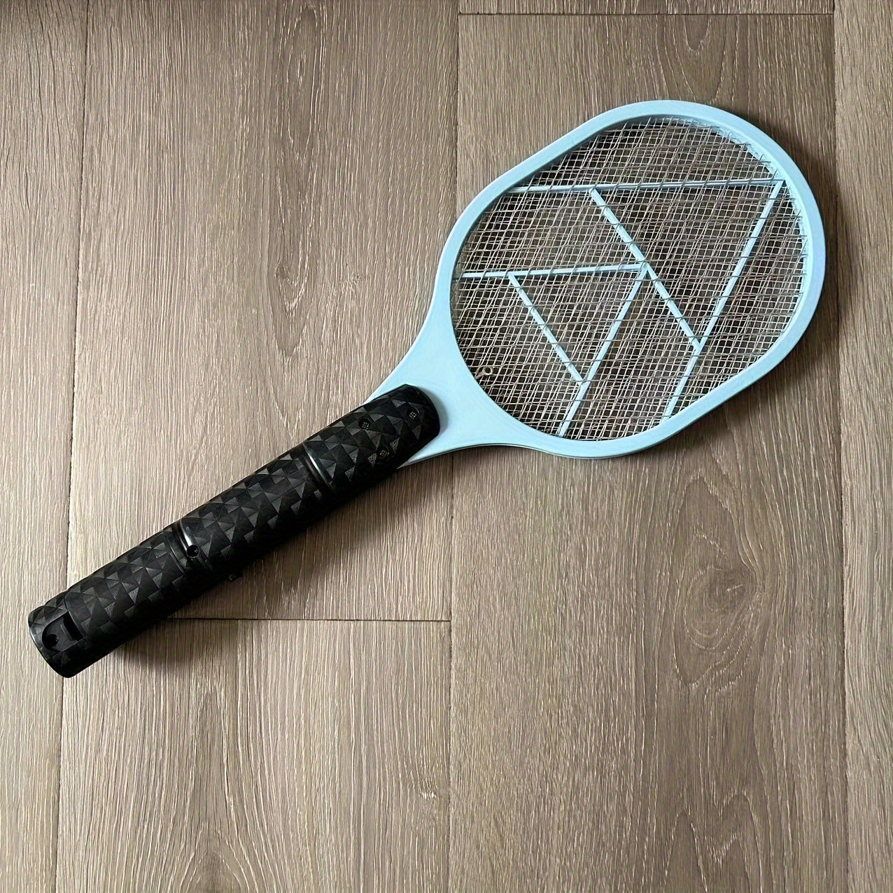 Electric fly and mosquito swatter that operates on batteries (AA batteries not included), made of durable plastic/aluminum/tin.