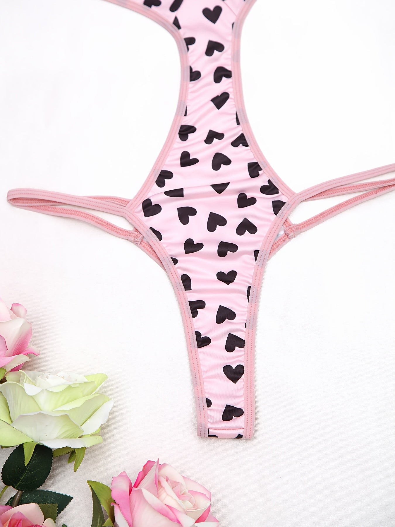 Women's sexy heart pattern bodysuit made of 90% polyamide and 10% elastane knit fabric, ideal for adults.