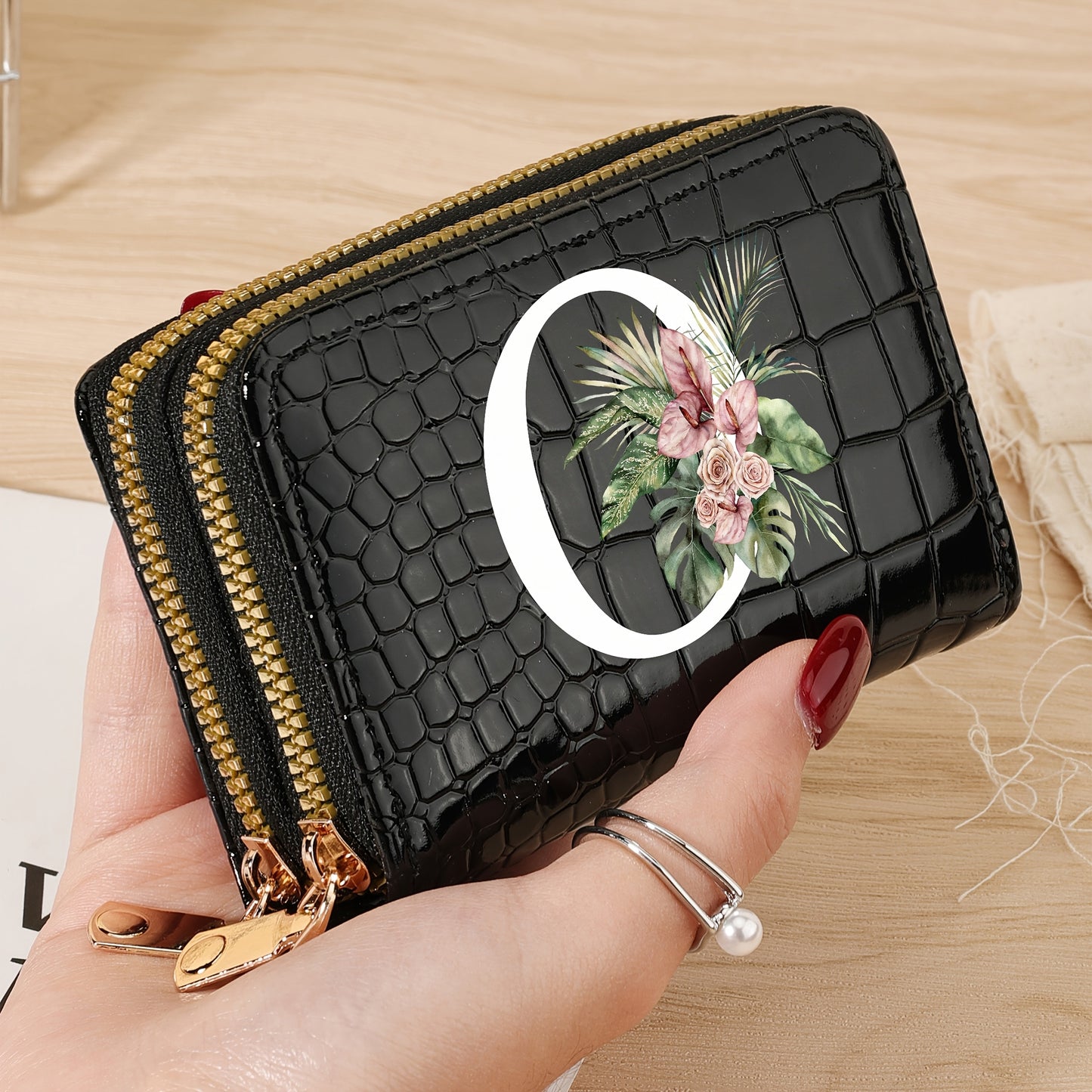 Women's credit card wallet with elegant floral letter print in black & white. Features large capacity, dual zipper, crocodile texture PU, lightweight design with nylon lining for everyday