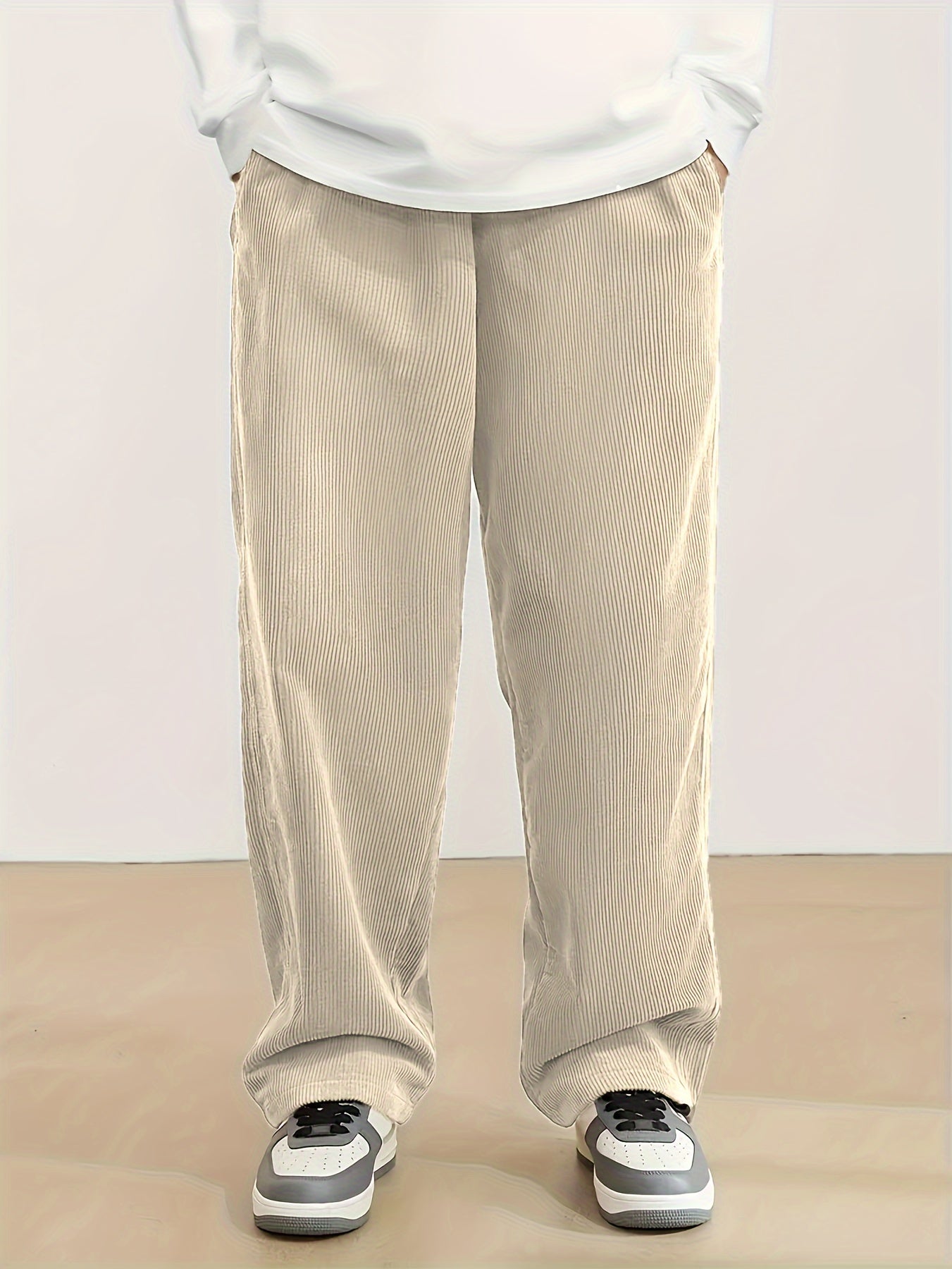 Plus size men's corduroy pants with drawstring, pockets, and straight-leg fit, made from 100% breathable polyester fabric for urban streetwear or outdoor activities.