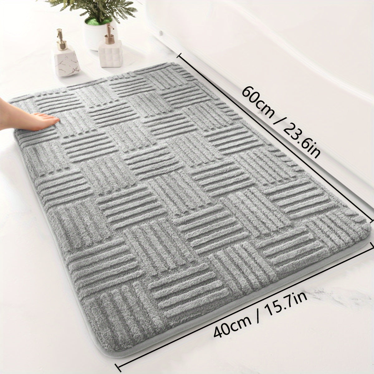 One piece of a thickened bathroom absorbent mat with a non-slip bathtub rug. Can also be used as a home entryway carpet with a solid color and stripe pattern. The mat is rectangular in shape and lightweight, machine-made with a PVC backing. Made of