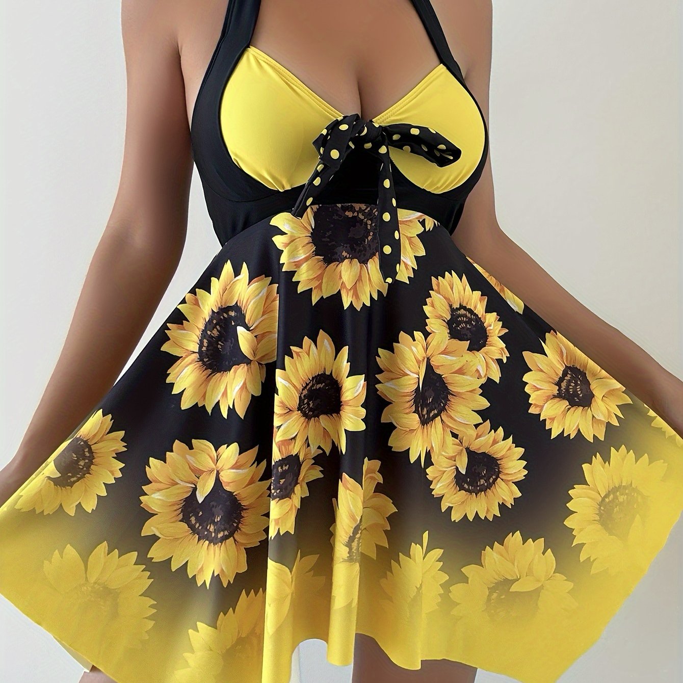 Women's 2 piece tankini set with sunflower print top, bow swim dress, and dot print bottoms.