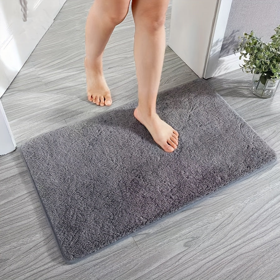 Machine-made oblong bath rug made from quick-dry absorbent knit fabric with non-slip features. Crafted from polyester fiber, this rug is 1.8cm thick and has a weight of 780gsm. Suitable for entryways, bedrooms, living rooms, and garages. Easy to care for