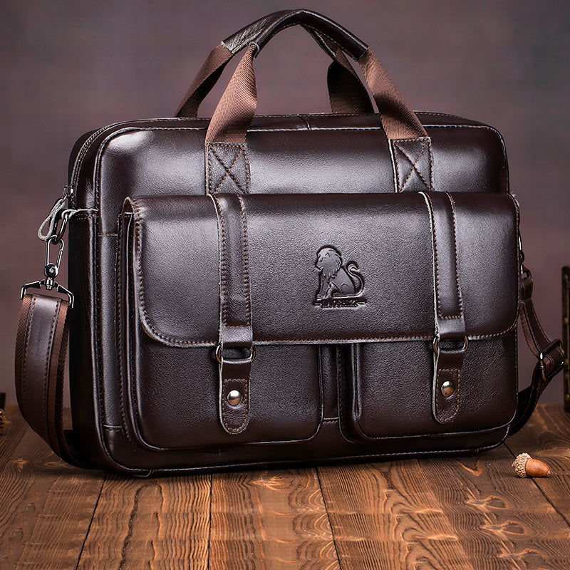 Brown leather briefcase with multiple compartments, adjustable shoulder strap, suitable for travel and professional activities.