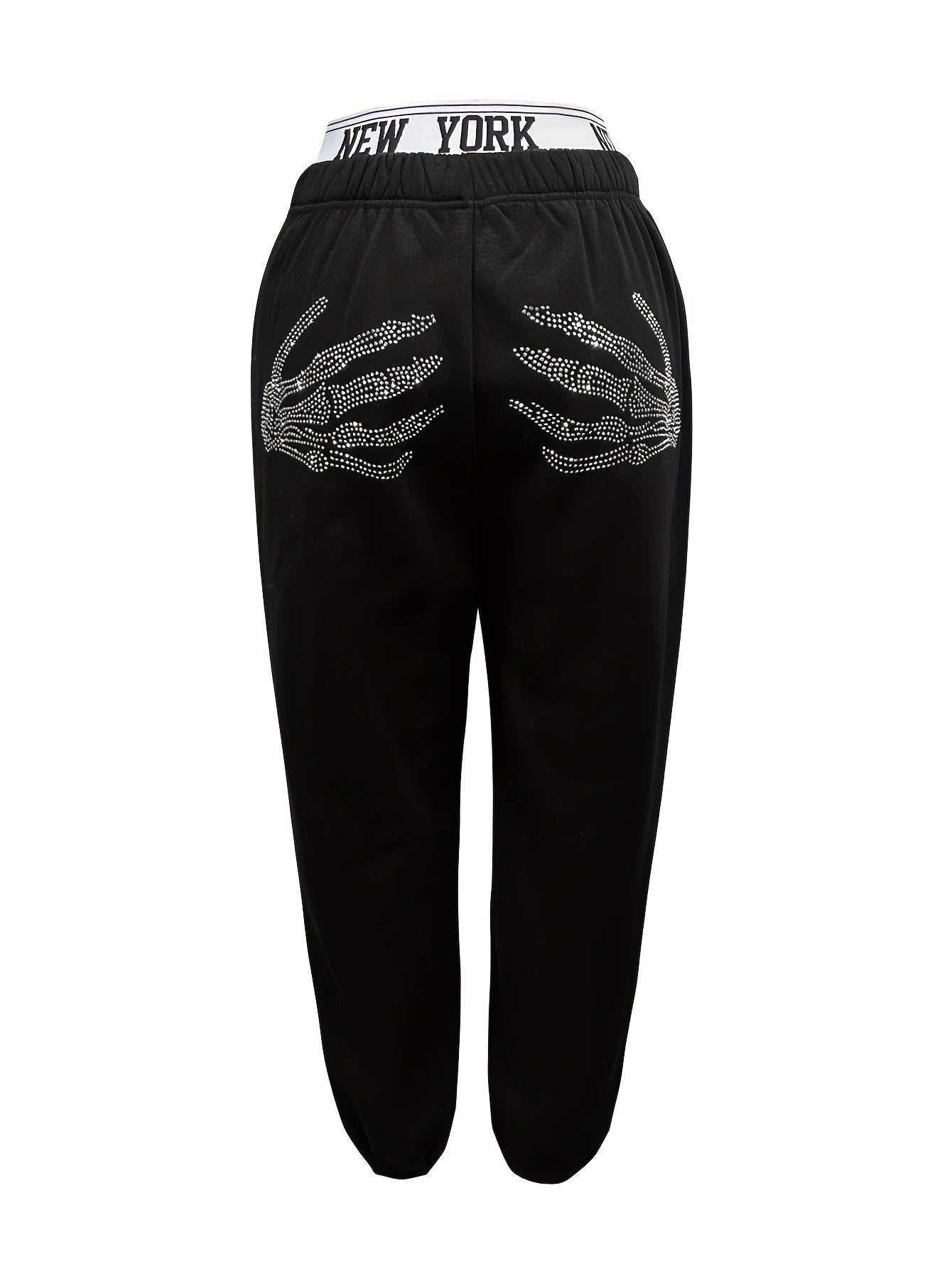 Women's casual jogger pants with elastic waistband, skeleton hands embellishment, and letter detail. All season knit joggers with cuffed ankles.