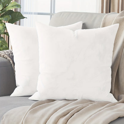 Two contemporary white throw pillow covers measuring at 45.72x45.72 cm made from soft polyester with zipper closure for home décor, machine washable.