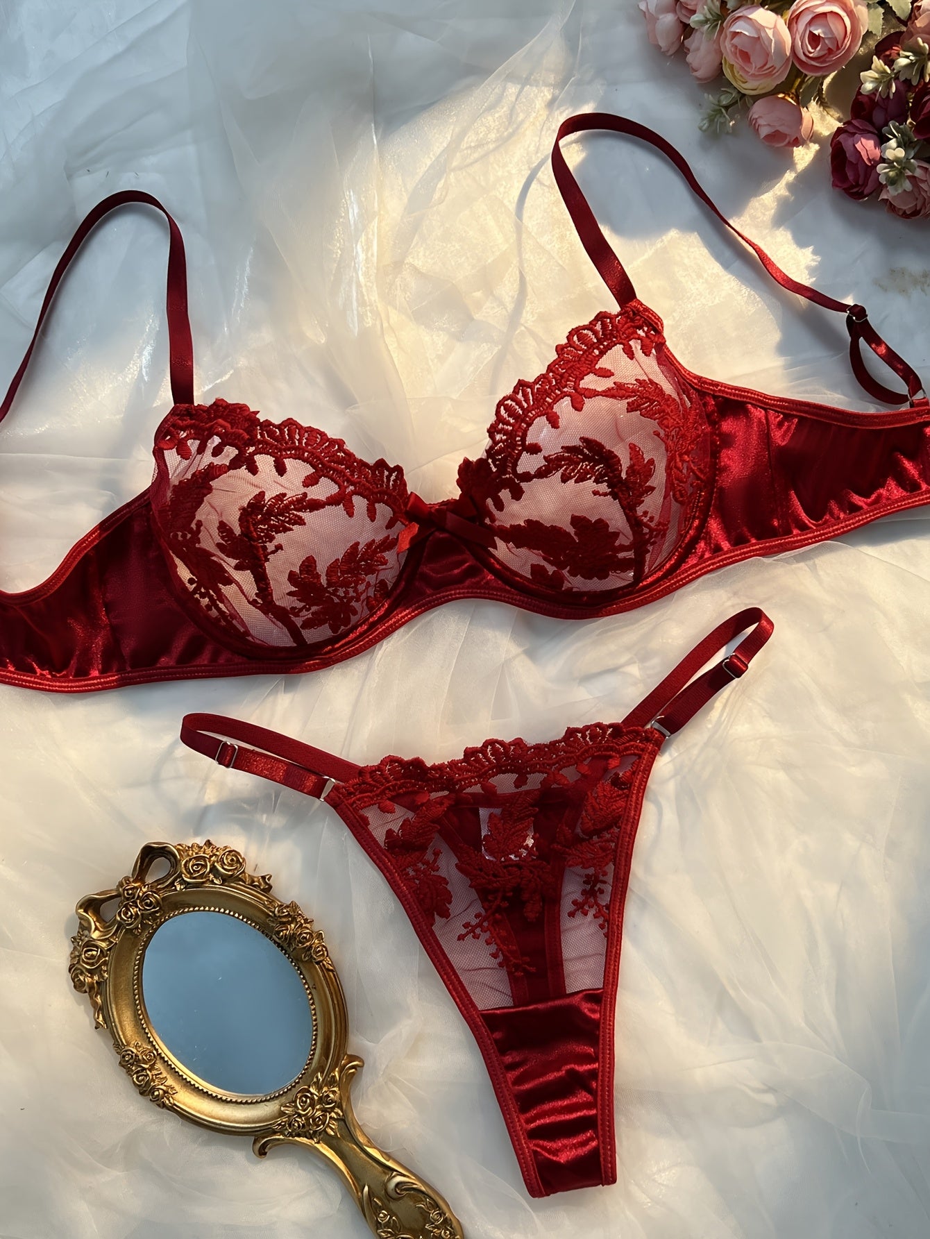 Floral embroidered lingerie set in burgundy, made from 97% polyester and 3% elastane knit fabric. Features medium support, no padding, thong panty, and drop waist - perfect as a Valentine's