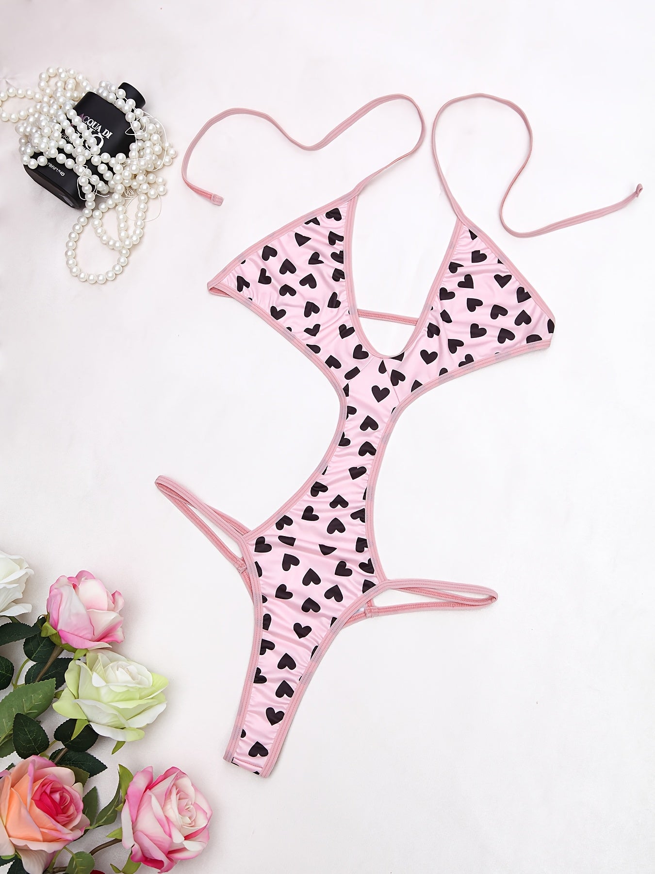 Women's sexy heart pattern bodysuit made of 90% polyamide and 10% elastane knit fabric, ideal for adults.