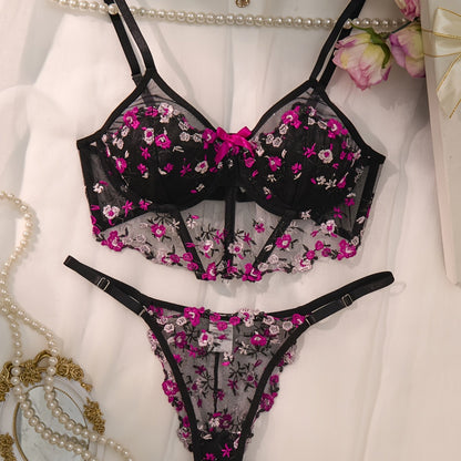 Stylish black lingerie set with floral embroidery, sheer mesh bra, low-rise thong, intricate back detailing, ideal for parties and everyday wear.