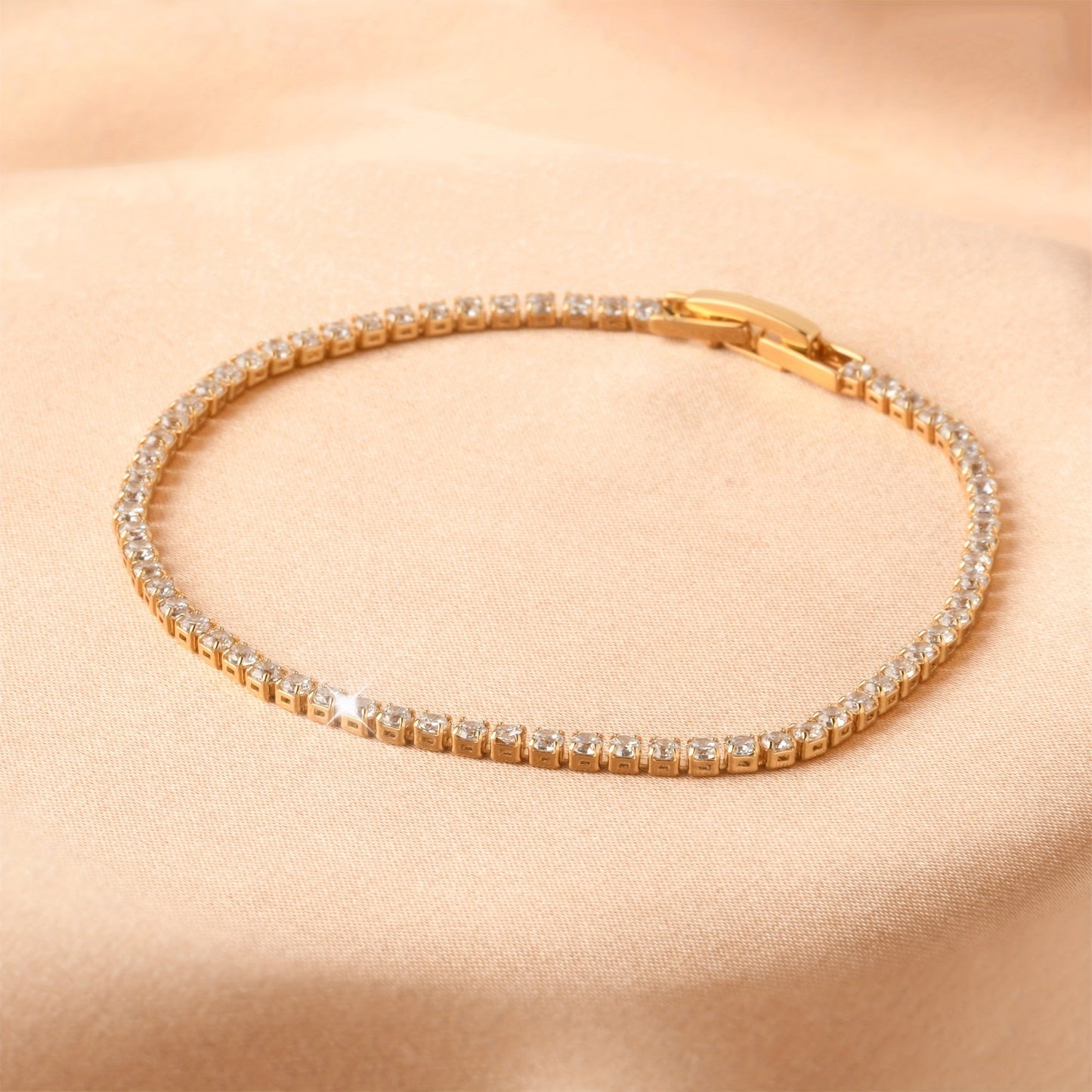 Golden plated copper hand jewelry accessory, featuring inlaid shiny zirconia stones in a tennis bracelet design. Perfect gift for Mother's Day.