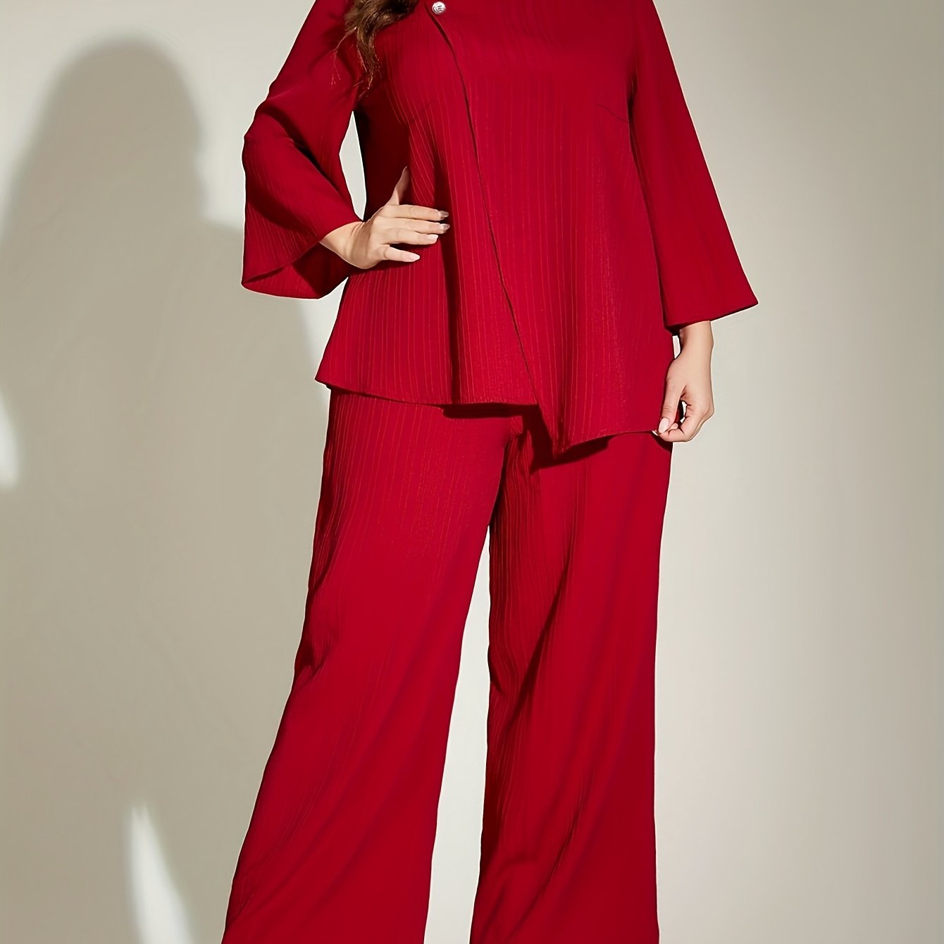 Chic red ribbed suit set for elegant plus size women, includes 3/4 sleeve top and wide-leg pants. Made of polyester, machine washable.