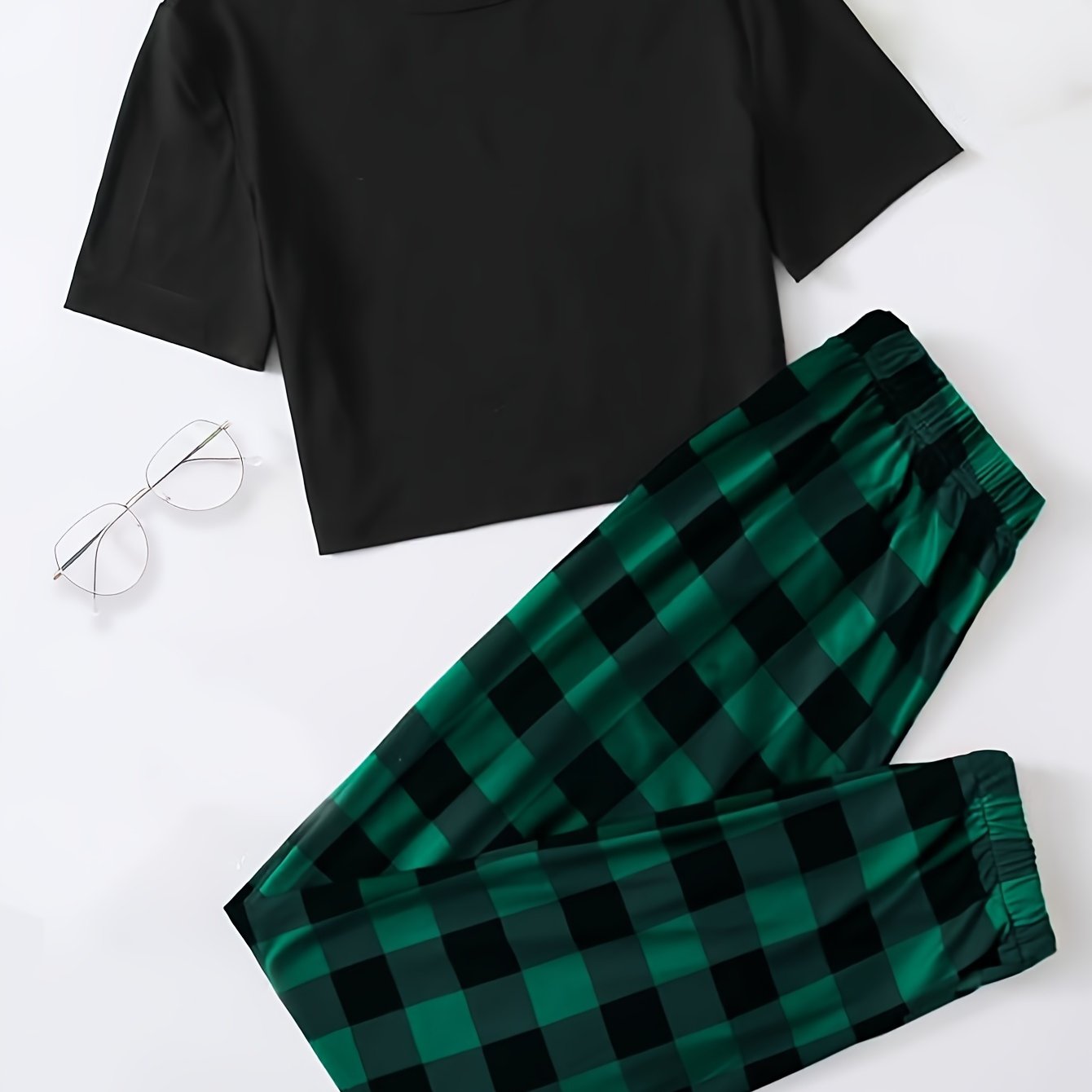 Plaid pajama set for women featuring a short sleeve top and elastic waistband pants.