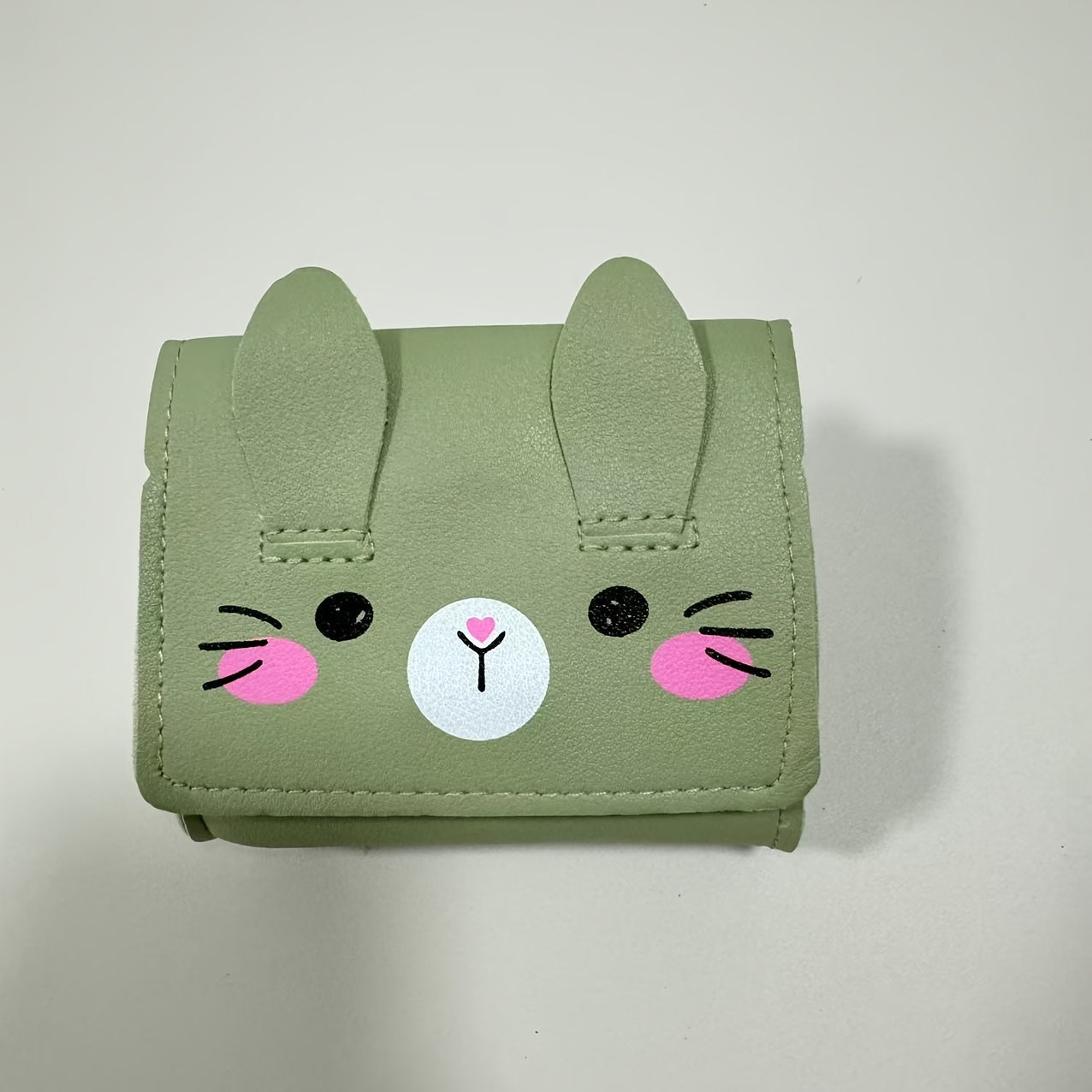 Cute bunny-themed mini crossbody bags in faux leather with adjustable strap. Includes cartoon coin purse and shoulder handbag in various colors. Bunny accessories available.