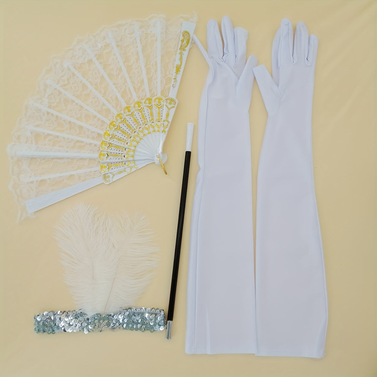 A collection of 1920s masquerade party accessories including gloves, faux feather hair clips, smoke tube fans, and other dress embellishments for women.