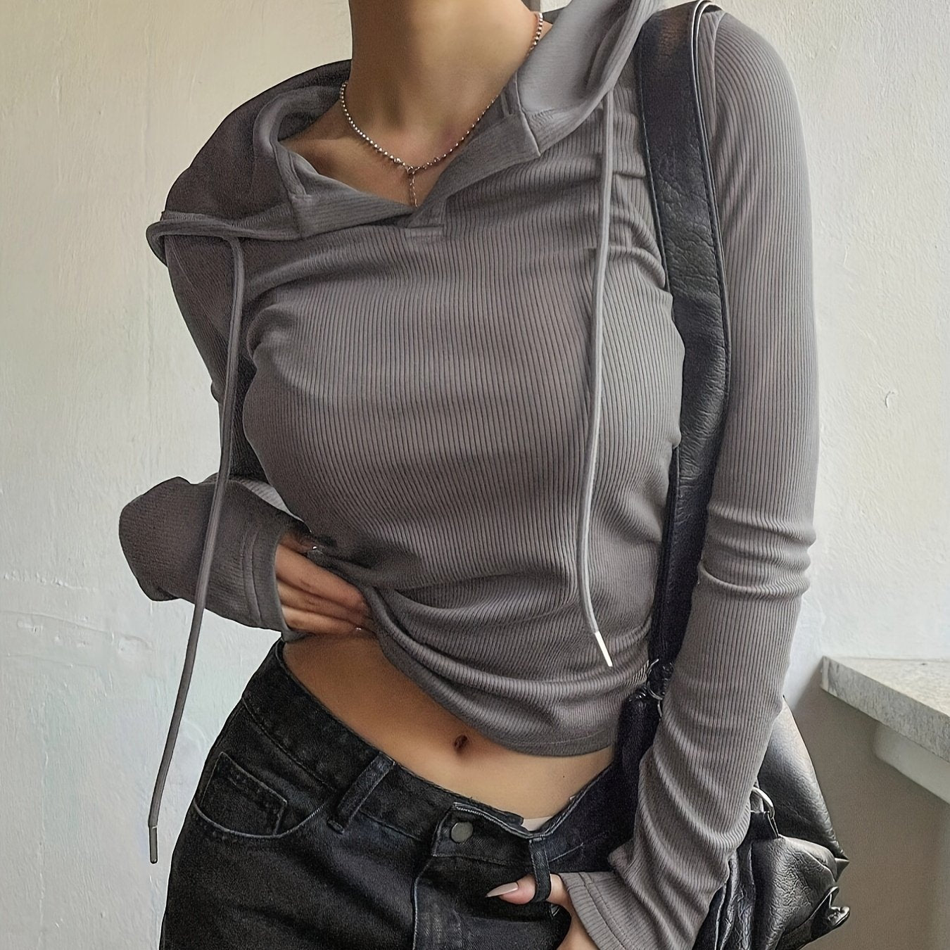 Light gray hooded crop top with drawstring for women, made from a stylish and comfortable polyester blend knit fabric, perfect for spring/fall casual wear.