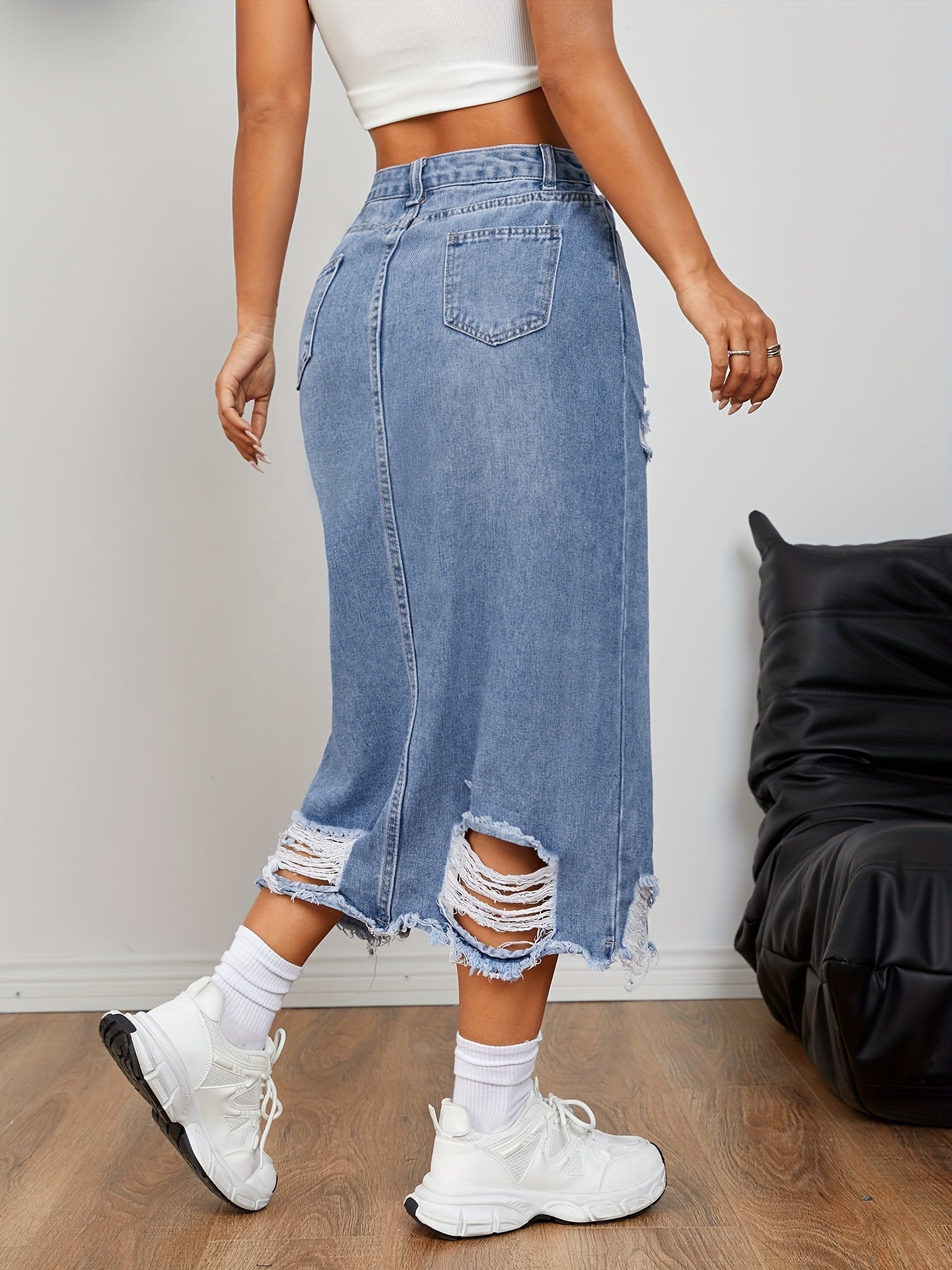 Casual distressed denim skirt with raw hem and slit for women.