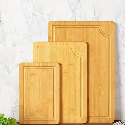 Set of 3 bamboo cutting boards with juice grooves, perfect for chopping meat and veggies. Features easy grip handles and makes a great kitchen gadgets gift.