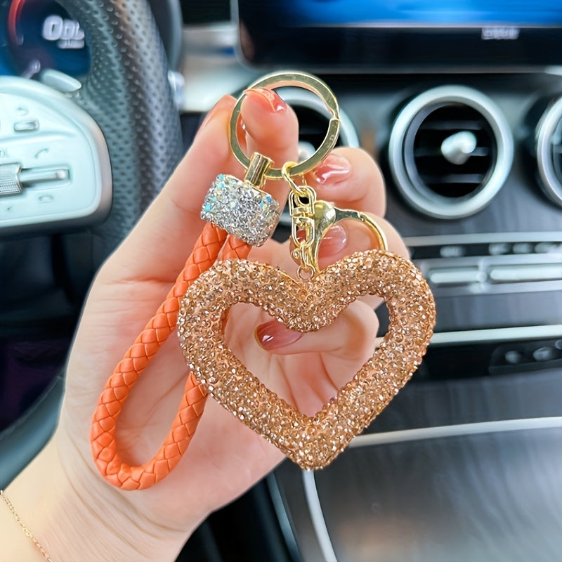 Heart-shaped resin keychain adorned with sparkling rhinestones, featuring a fun cartoon design for a touch of whimsy. Complete with a lobster clasp for easy attachment, this unique keyring is perfect for adding a festive touch to your holiday decor.