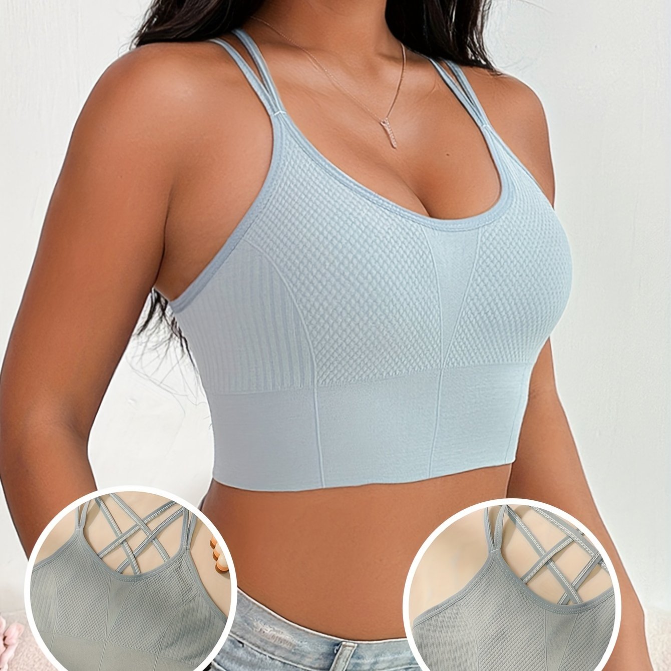 White sports bra for women with sleeveless design, crisscross back, and breathable nylon-elastane blend for push-up support.