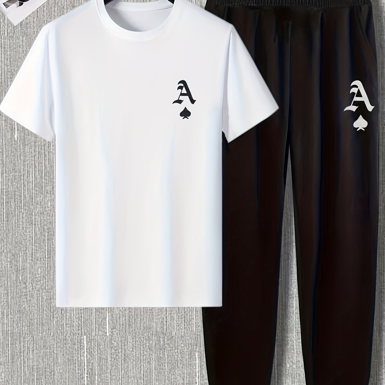 Men's casual sports set with short sleeve round neck t-shirt and regular fit pants, made of polyester and spandex blend for breathability and stretch. Printed logo on shirt.