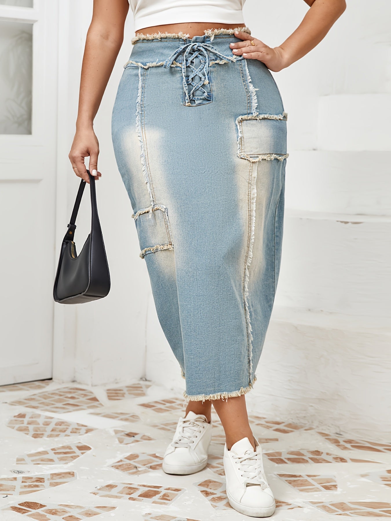 Women's high-waist denim midi skirt with frayed hem and lace-up details in a gradient light blue to dark wash. Raw edge detailing, versatile for spring/summer/fall.