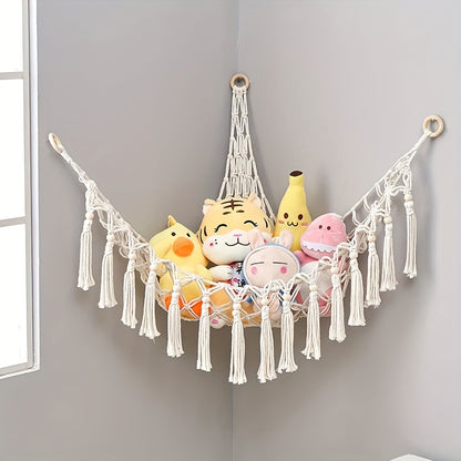 Handmade macrame wall storage net with hooks for toys and plushies. Versatile decor for living room, bedroom, or playroom.