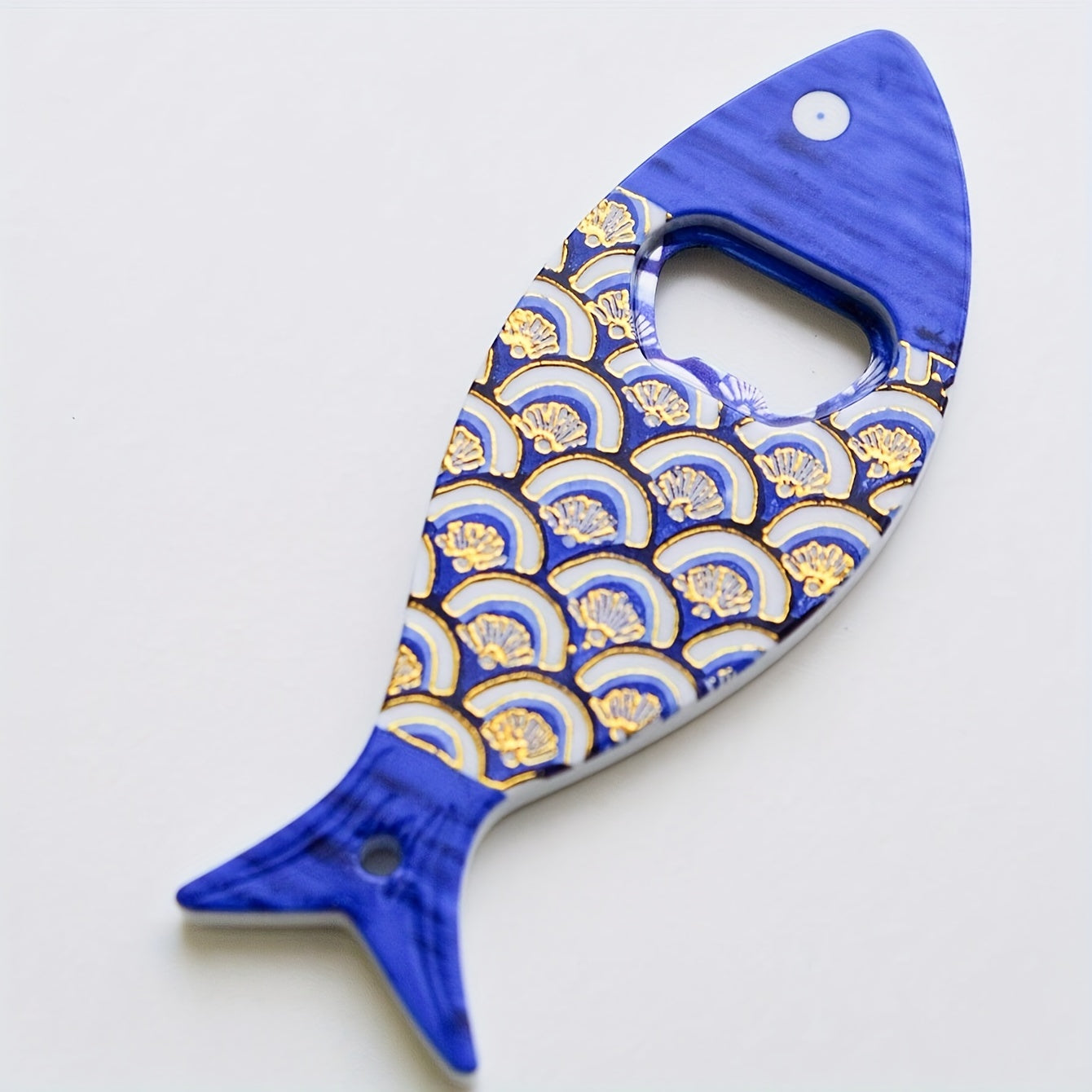 Fish-shaped cap opener with magnet for refrigerator decoration, no power required.