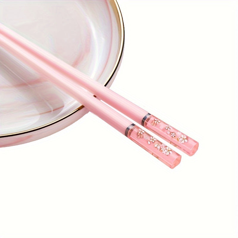 One set of Pink Cherry Flower Amber Chopsticks, ideal for Chinese and Korean style meals such as fast food, sushi, and ramen. Perfect for family meals and reusable kitchen supplies.