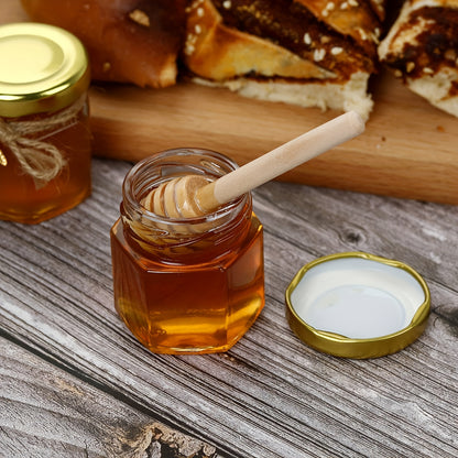 Stylish hexagonal glass jar with gold lid and wooden bucket ideal for preserving food and serving at events. Available in various packaging options for weddings, bridal gifts, and family gatherings. Also great for storing honey creatively.