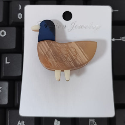 Animal-shaped acrylic duckling brooch pin with color block design is a cute fashion accessory for collars and clothing.