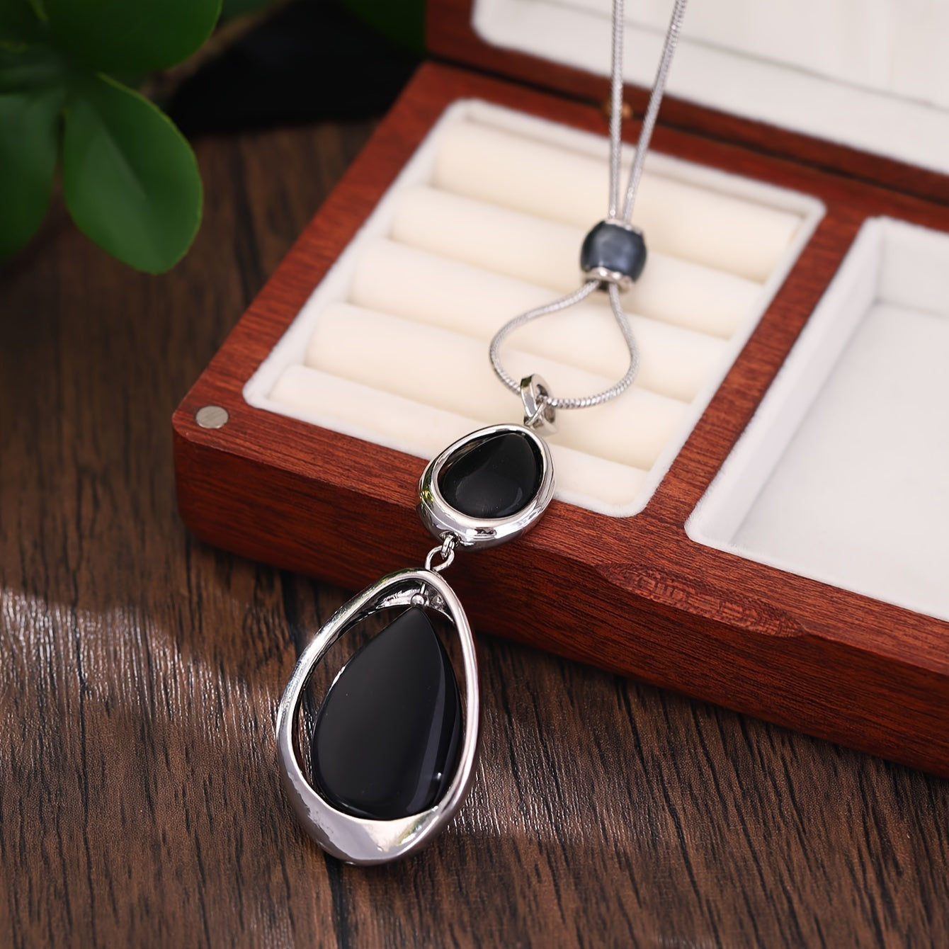 A stylish and sophisticated black stone geometric pendant necklace, perfect for women's accessories. Made from trendy zinc alloy, this long necklace is ideal for daily wear, parties, proms, vacations, and makes a great jewelry gift.