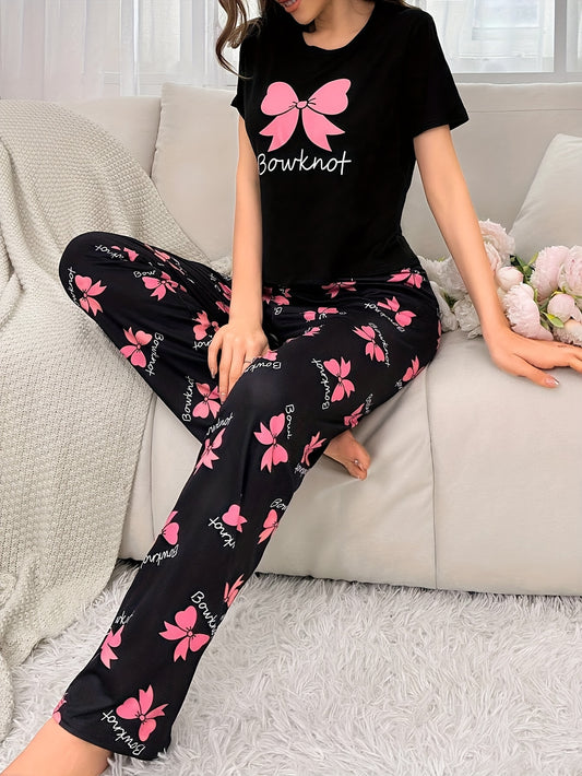 Cozy bowknot pajama set for women with short sleeves and elastic waistband pants. Made from soft, machine washable polyester blend in black with pink butterfly print.