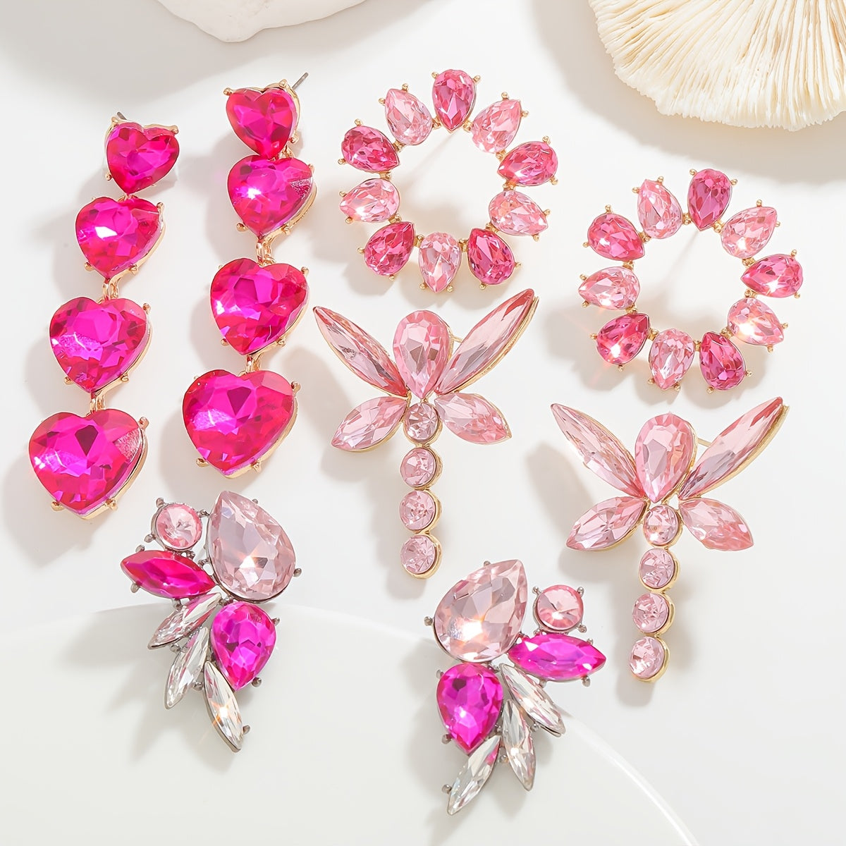 Add a touch of sparkle this Valentine's Day with our Pink Heart & Crystal Winged Drop Earrings. Featuring an elegant bling style, these earrings are made of Zinc Alloy with Stainless Steel Posts, perfect for weddings, parties, and gifts. The Round