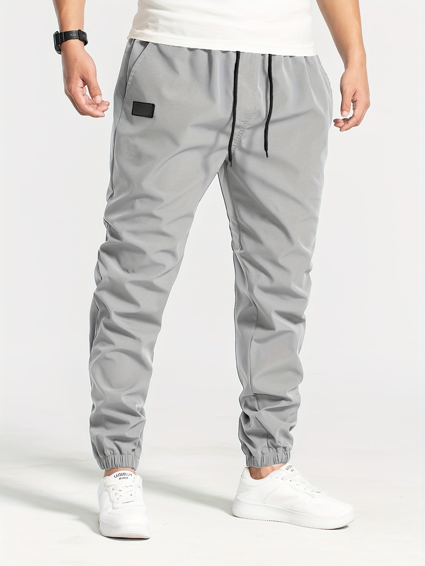 Three-pack of men's loose casual pants in 100% polyester solid color, featuring multi-pocket waist drawstring and non-stretch woven fabric, part of the Spring Collection, 180g/m².