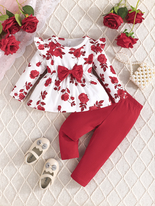 Girls' floral print top with bow detail and matching pants set in cute polyester knit fabric. Regular fit for outdoor activities.