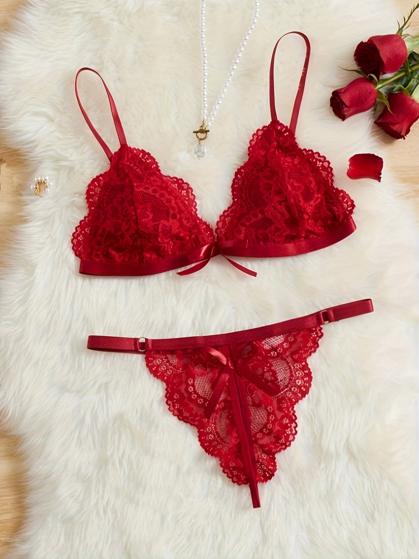 A women's lace lingerie set with a hollow design, open-crotch style, sexy bow detail, non-transparent bra, triangle cup shape, and Y2K style.