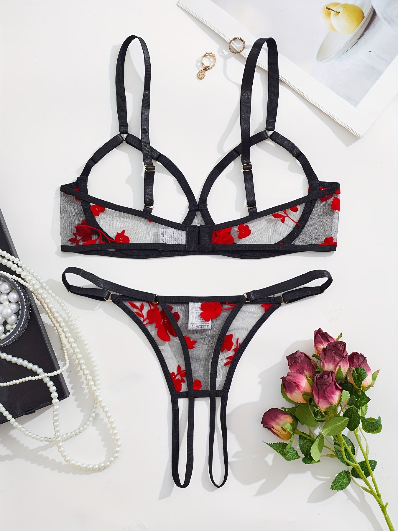 Elegant black and red floral lace bralette and thong set for women.