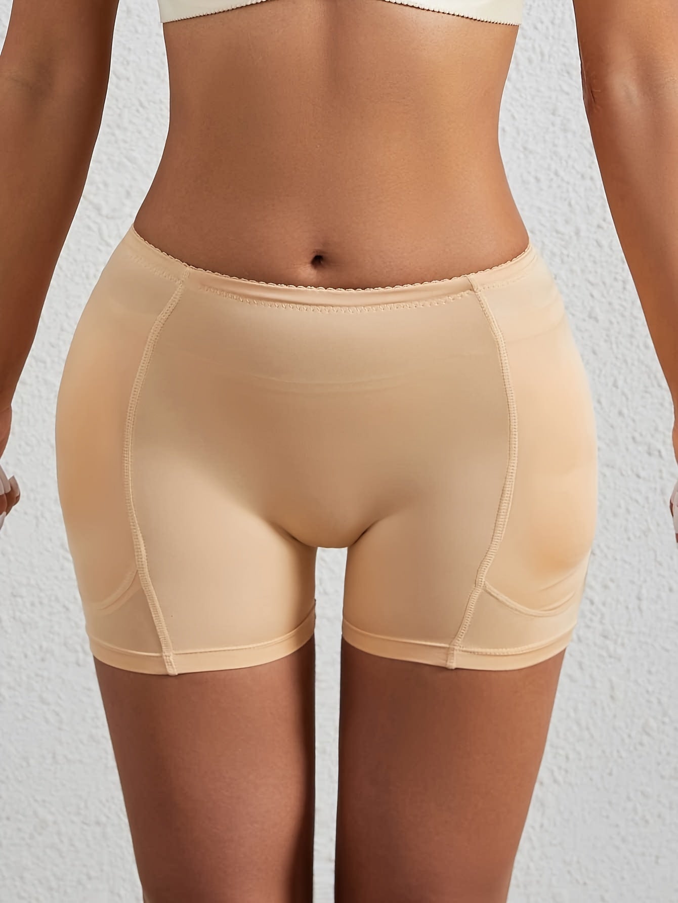 Shapewear shorts for women with padded butt lift, seamless fabric, anti-roll waist trainer, and tummy control.