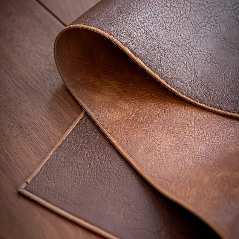 Dual-sided faux leather desk mat in elegant brown with stitched edges. Ideal for office, gaming, and writing. Versatile rectangular mouse pad for laptops and keyboards. Durable and