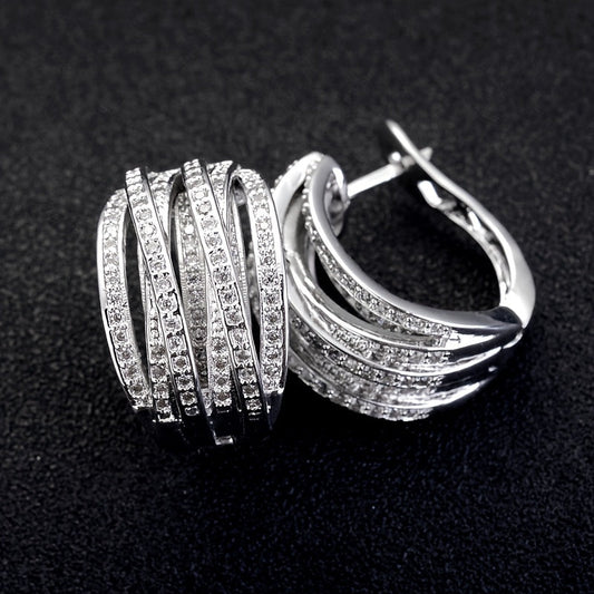 Chic and understated, these Silvery Overlap Wrap Hoop Earrings feature shiny zirconia inlays, making them the perfect fashion accessory for parties and weddings. An ideal gift for a special occasion.