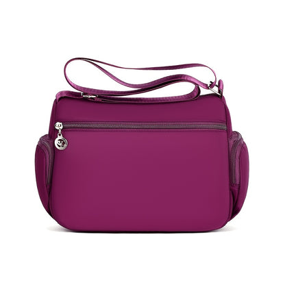 Women's versatile crossbody bag with adjustable strap, multiple compartments, zipper closure, and polyester lining for shopping, office, and travel, available in multiple colors.