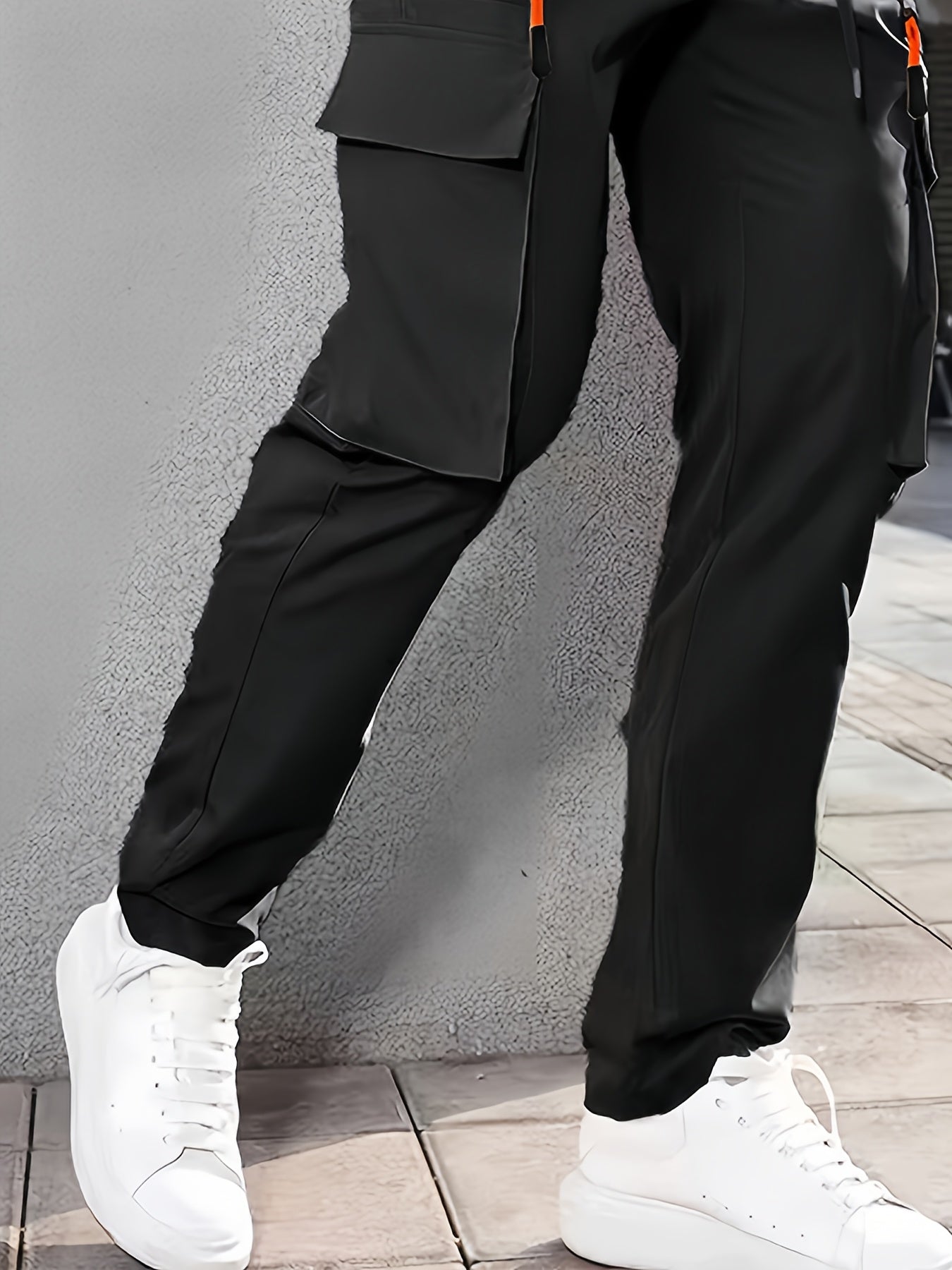 Men's casual cargo pants made of 100% polyester with an elastic waist, multi-pocket design, regular length, and loose fit for spring and fall wear.