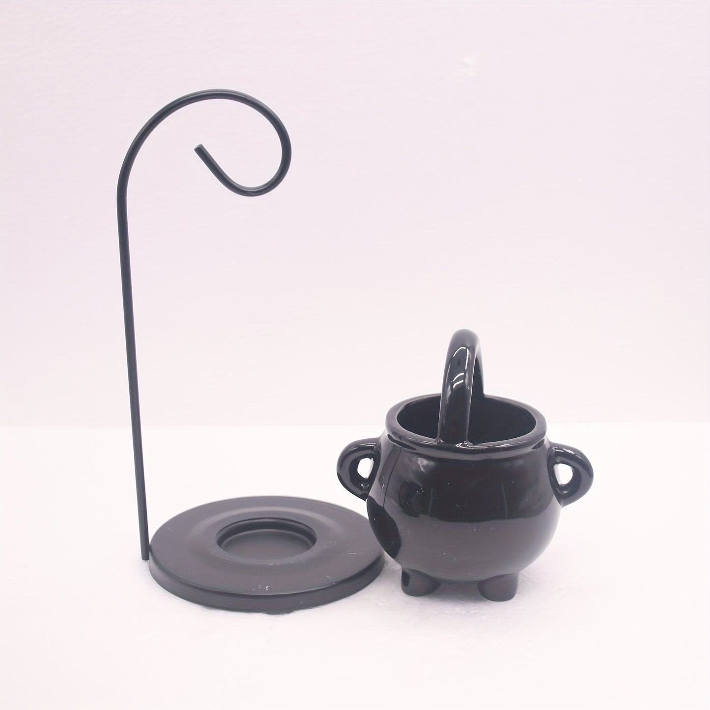 Black ceramic cauldron oil burner with iron holder, glossy finish, aroma diffuser and wax melt warmer, tealight candle holder for home decor. No incense needed.