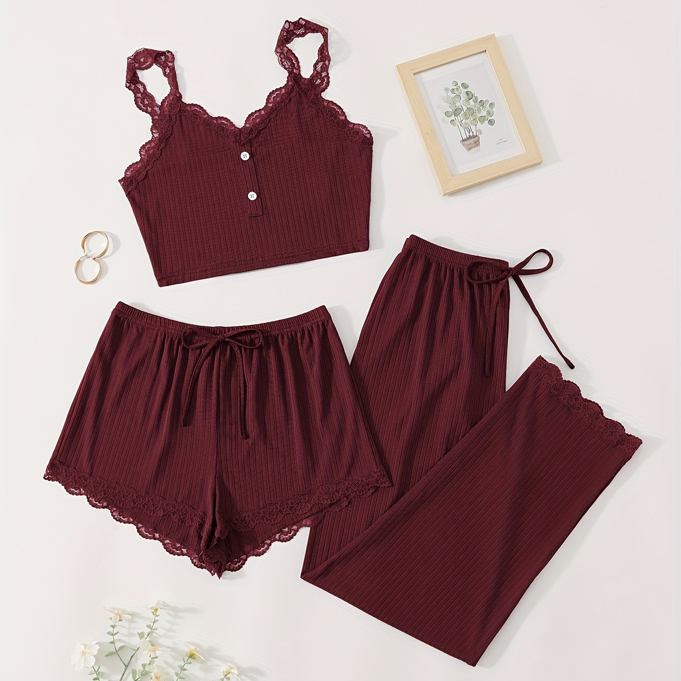 Three-piece set of women's ribbed fabric pajamas with suspender top and shorts.