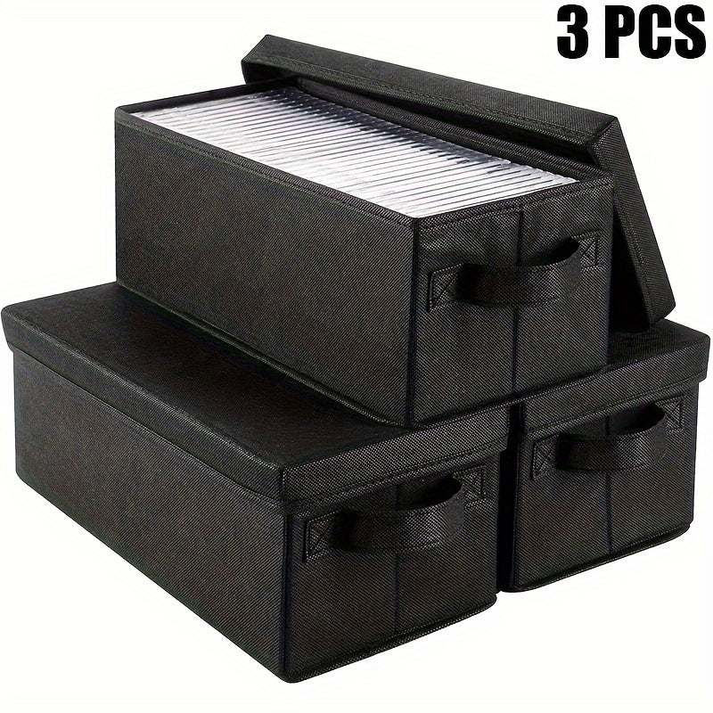 Set of three fabric CD storage boxes with lids and handles, featuring a brushed finish. Can be used as a multipurpose recessed shelf DVD organizer. This electricity-free media case is perfect for use at home, in the office, or in the car. Can hold up to