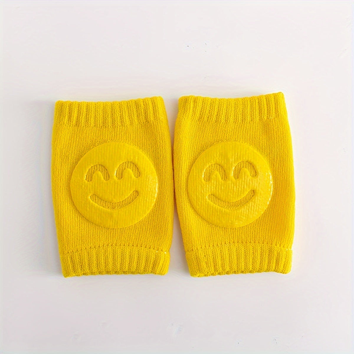 Two pairs of knee pads for toddlers to use while crawling, made from non-slip, phthalate-free polyester material. These elbow and knee protectors are designed for children aged 0-3 years old, providing safety for early walkers with a cheerful happy face