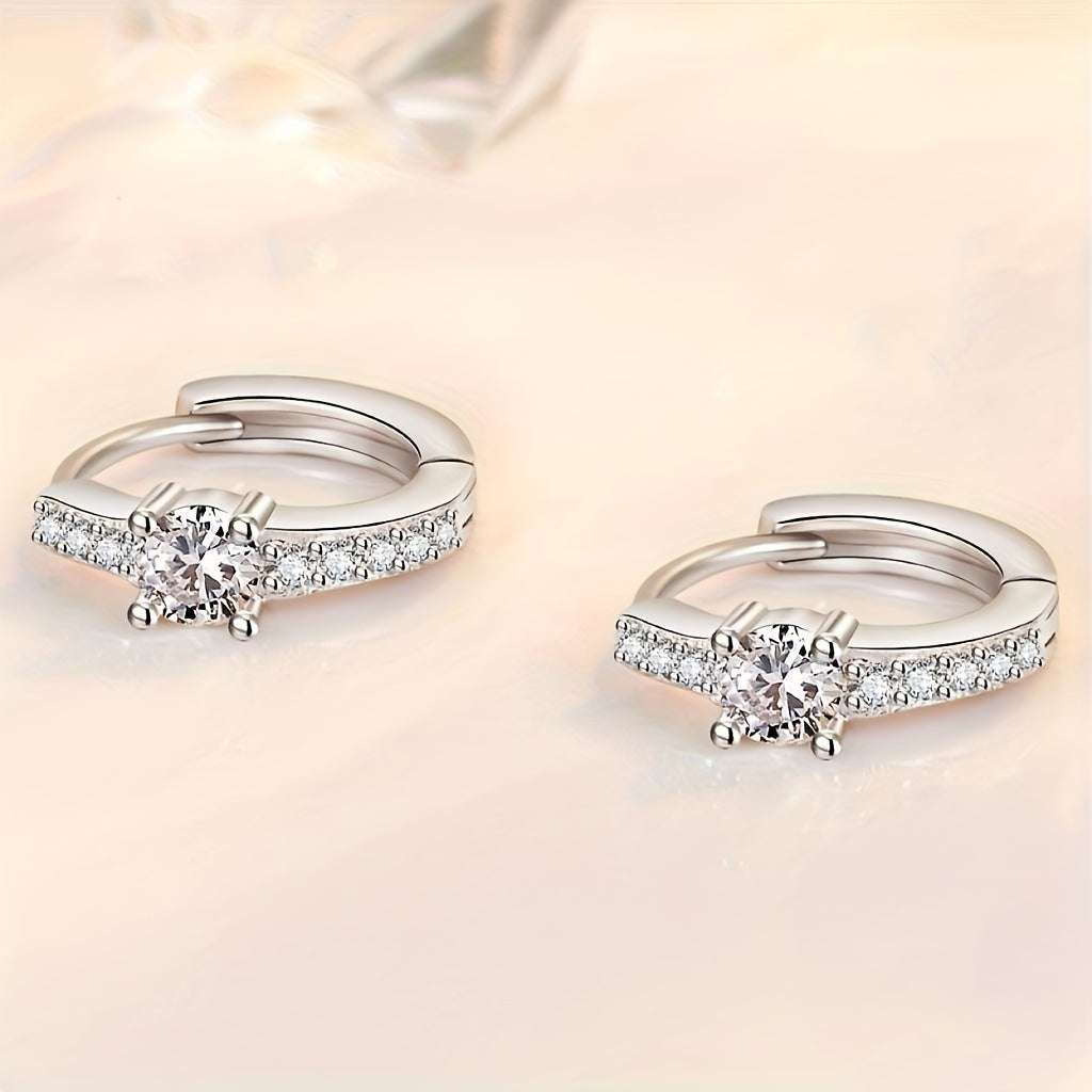 A stylish pair of retro-inspired S925 Silvery earrings, featuring exquisite rhinestones set in round hollow centers. These high-end and trendy accessories boast a luxurious shine, perfect for adding a touch of elegance to any outfit. With a sweet and