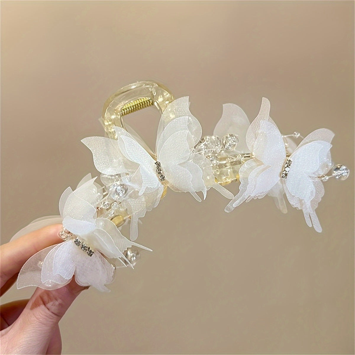 Stylish golden butterfly hair clip with crystal beads - perfect for chic updos & buns.