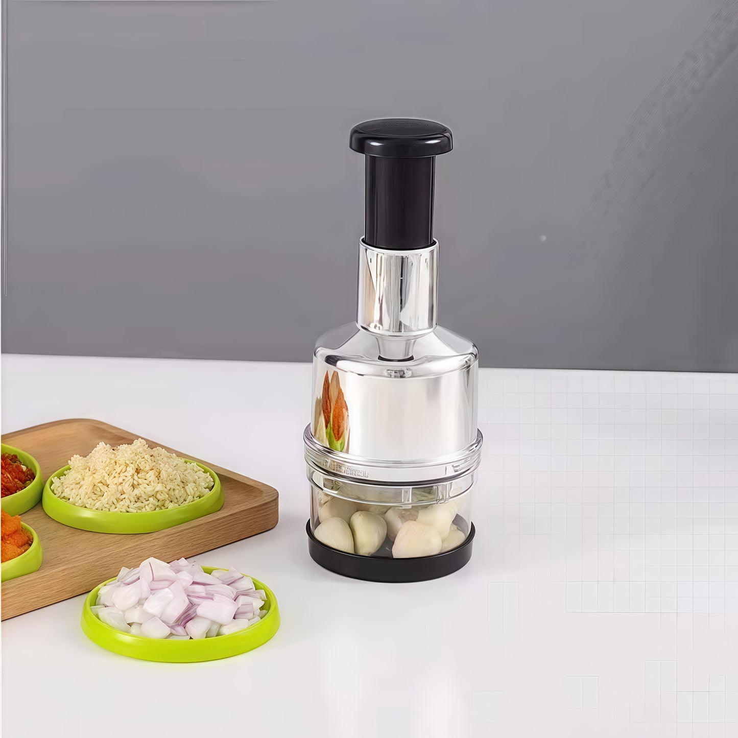 Handheld garlic press and food chopper with metal structure, no electricity needed.