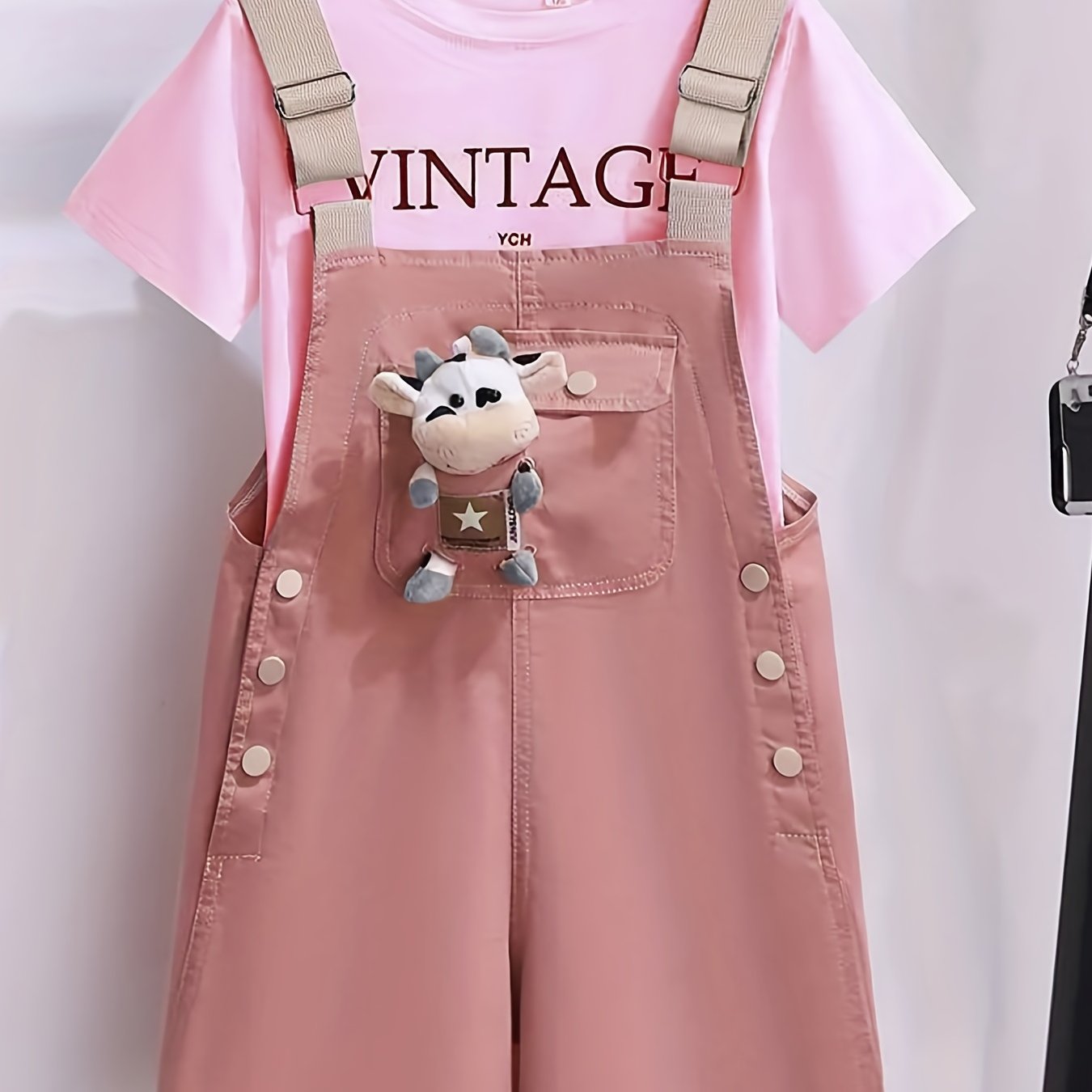 Girls' summer outfit with trendy suspenders and lightweight overalls for outdoor wear.